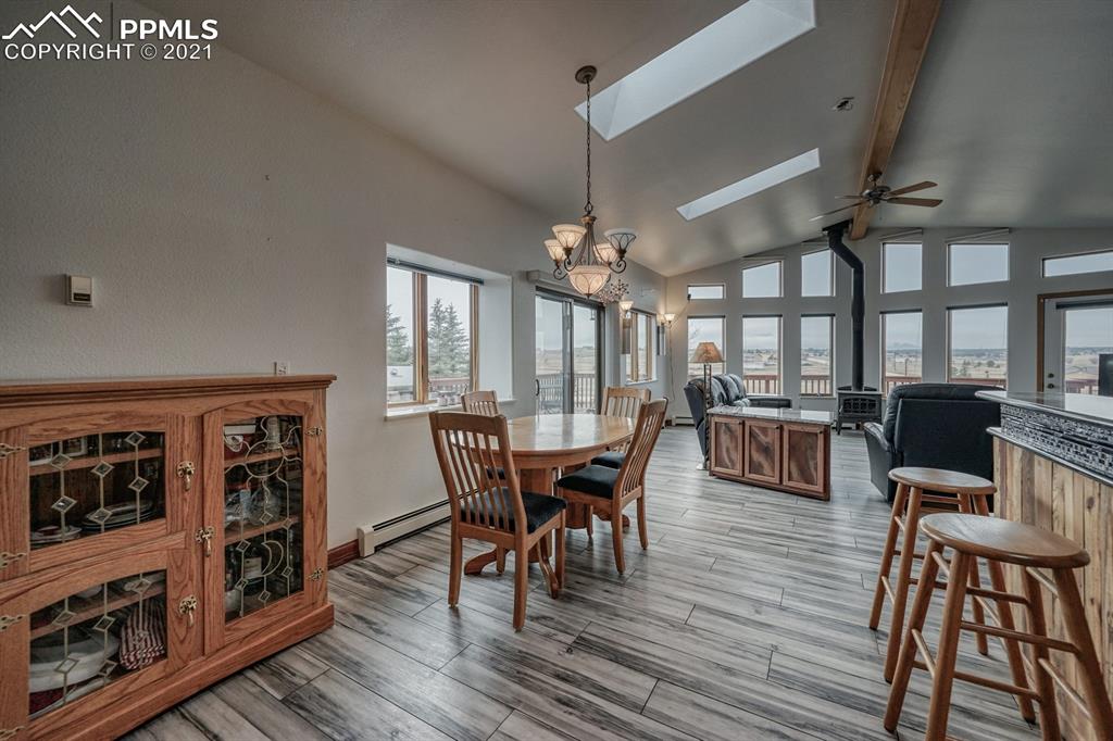 13770 Woodlake Road Elbert, CO 80106 - Photo 25 of 43 a view of a dining room with furniture and wooden floor