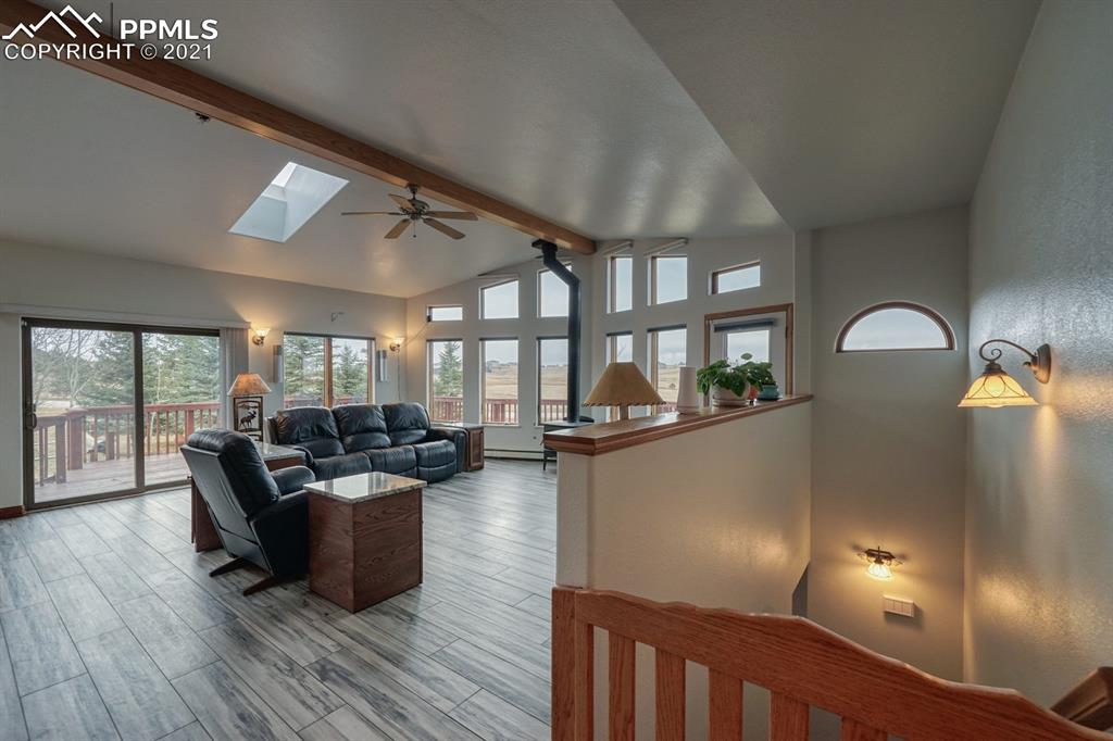 13770 Woodlake Road Elbert, CO 80106 - Photo 26 of 43 a living room with fireplace furniture and a large window