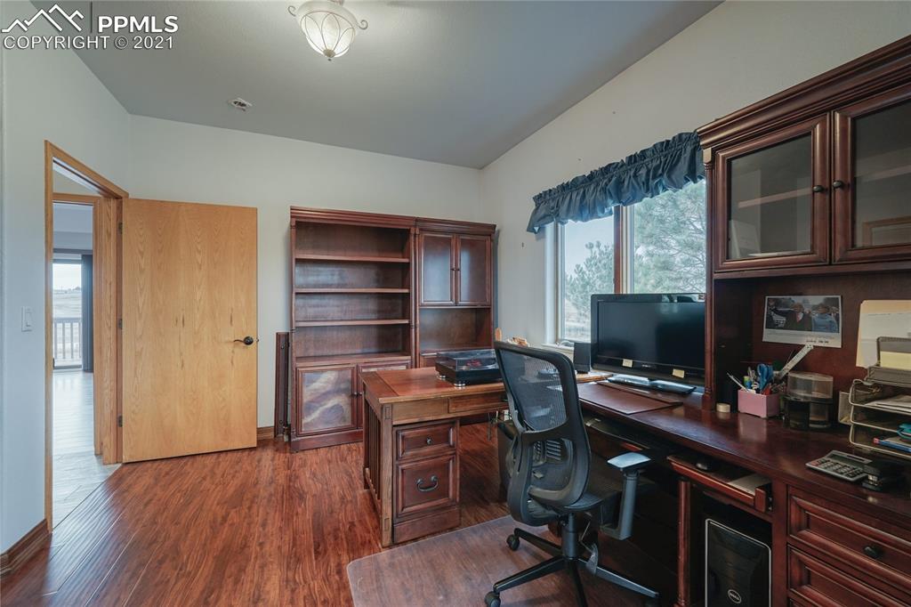 13770 Woodlake Road Elbert, CO 80106 - Photo 29 of 43 a view of a workspace with furniture and wooden floor