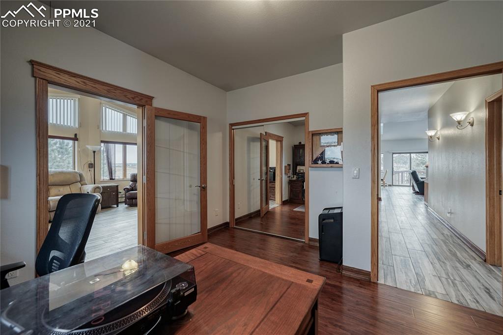 13770 Woodlake Road Elbert, CO 80106 - Photo 30 of 43 a living room with furniture and a wooden floor