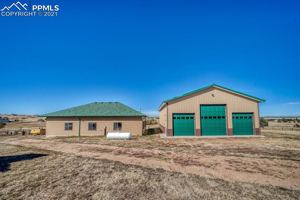 13770 Woodlake Road Elbert, CO 80106 - Photo 36 of 43 a front view of a house with a yard