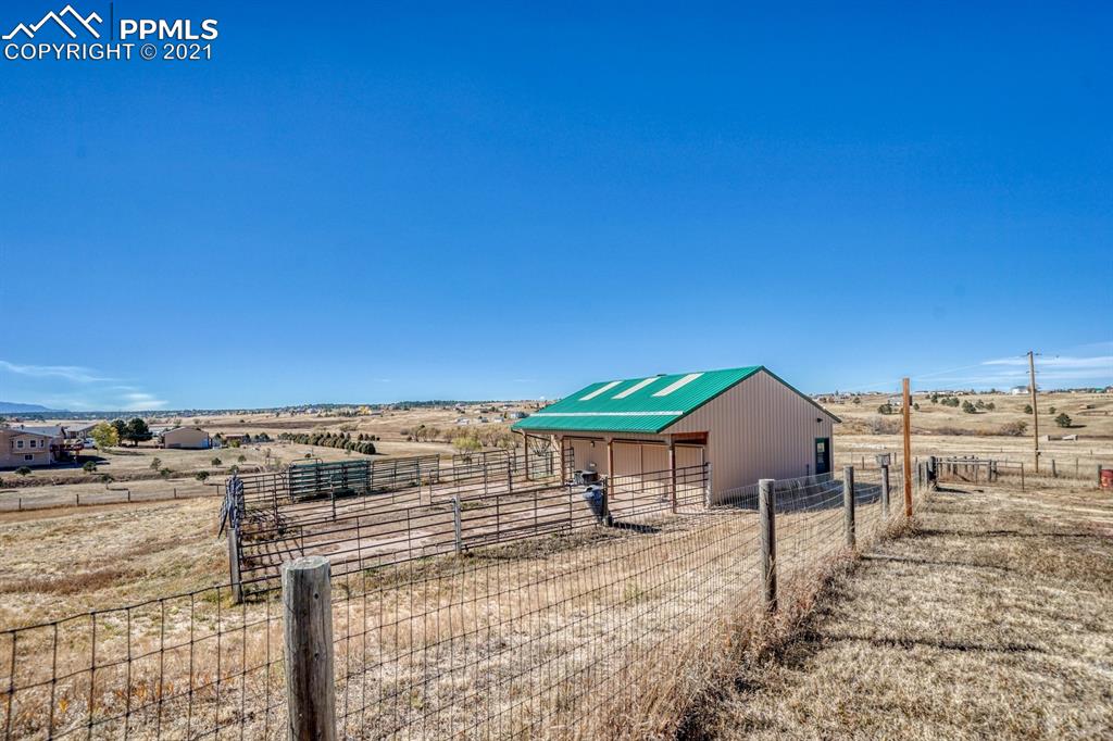 13770 Woodlake Road Elbert, CO 80106 - Photo 38 of 43 a view of a house with a backyard