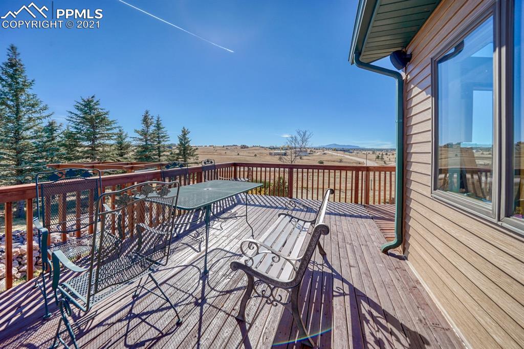 13770 Woodlake Road Elbert, CO 80106 - Photo 5 of 43 a view of balcony with wooden floor and seating space