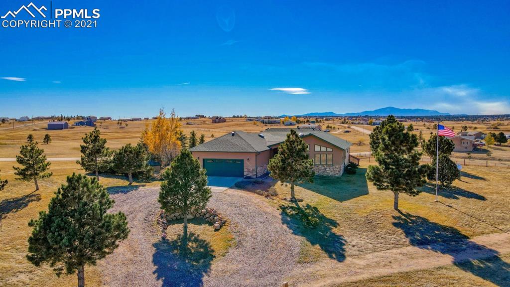 13770 Woodlake Road Elbert, CO 80106 - Photo 6 of 43 a view of a lake with a building in the background