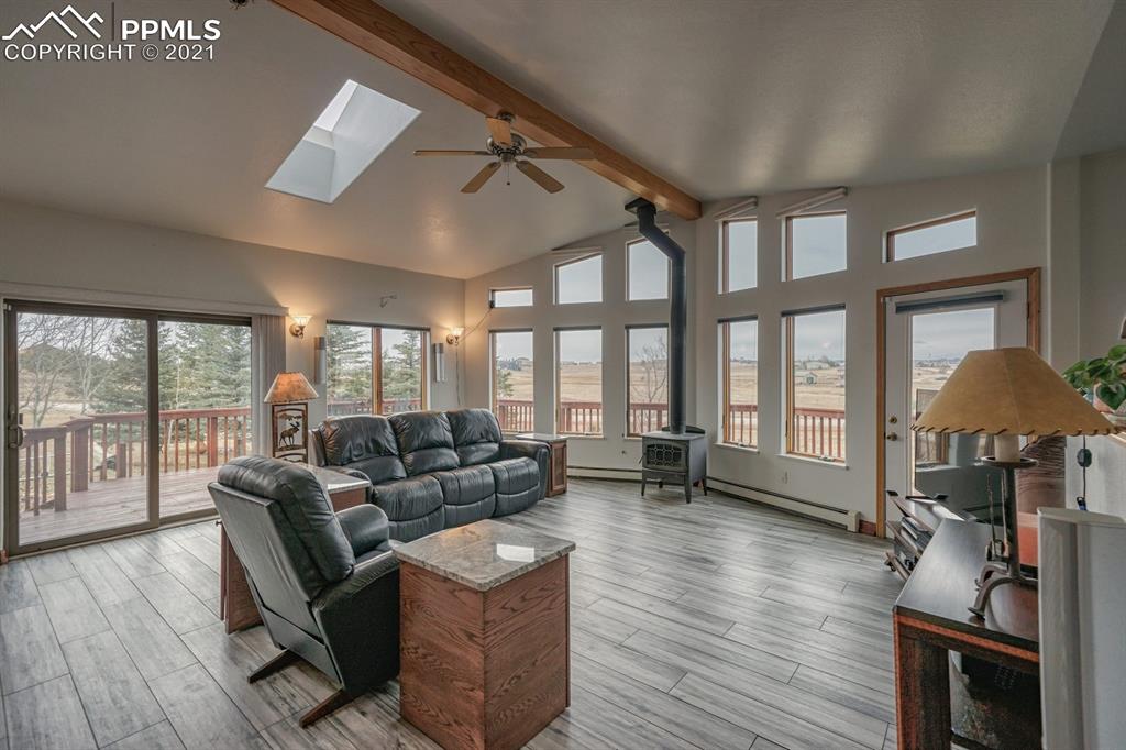 13770 Woodlake Road Elbert, CO 80106 - Photo 7 of 43 a living room with furniture and a floor to ceiling window