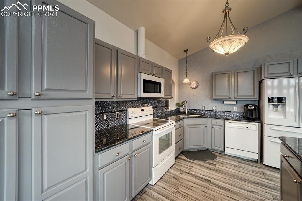 13770 Woodlake Road Elbert, CO 80106 - Photo 9 of 43 a kitchen with a sink stove and refrigerator