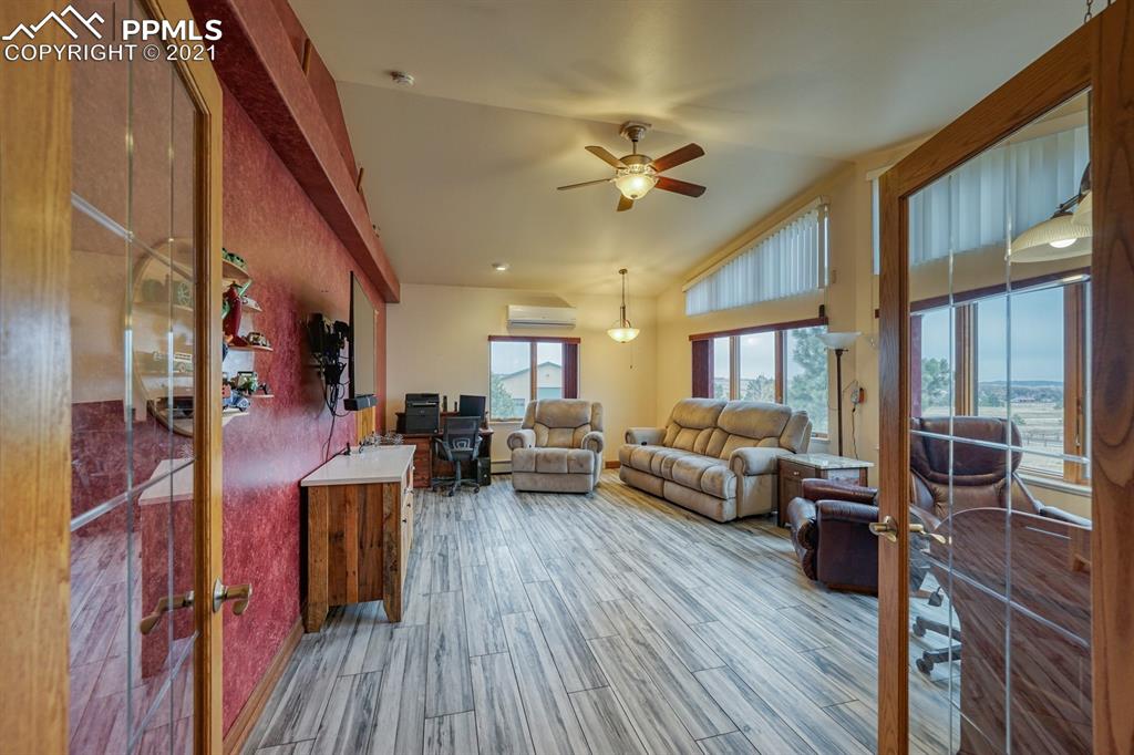13770 Woodlake Road Elbert, CO 80106 - Photo 10 of 43 a living room with furniture fireplace and wooden floor