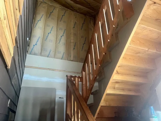 a view of staircase with wooden floor and a window