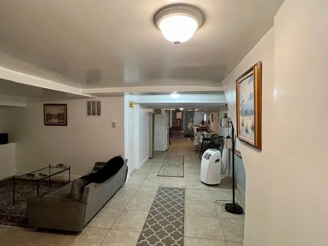 a hallway with couch and white walls