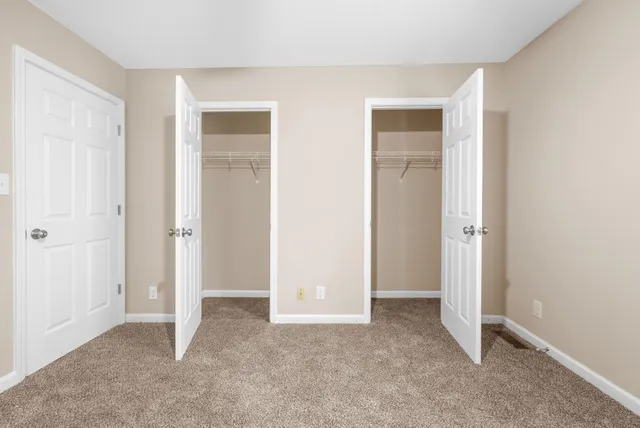 an empty room that has a grey walls
