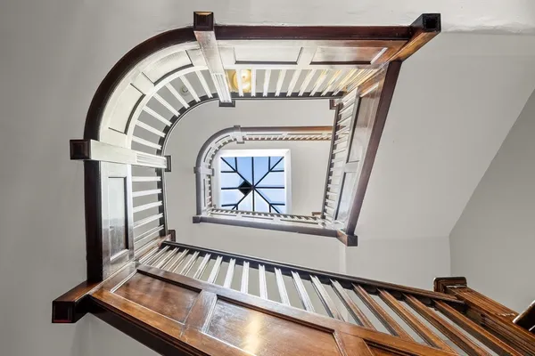 a view of staircase with a rug