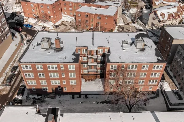 a view of a brick building with many windows