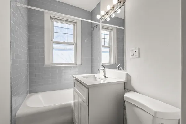 a bathroom with a sink toilet and tub