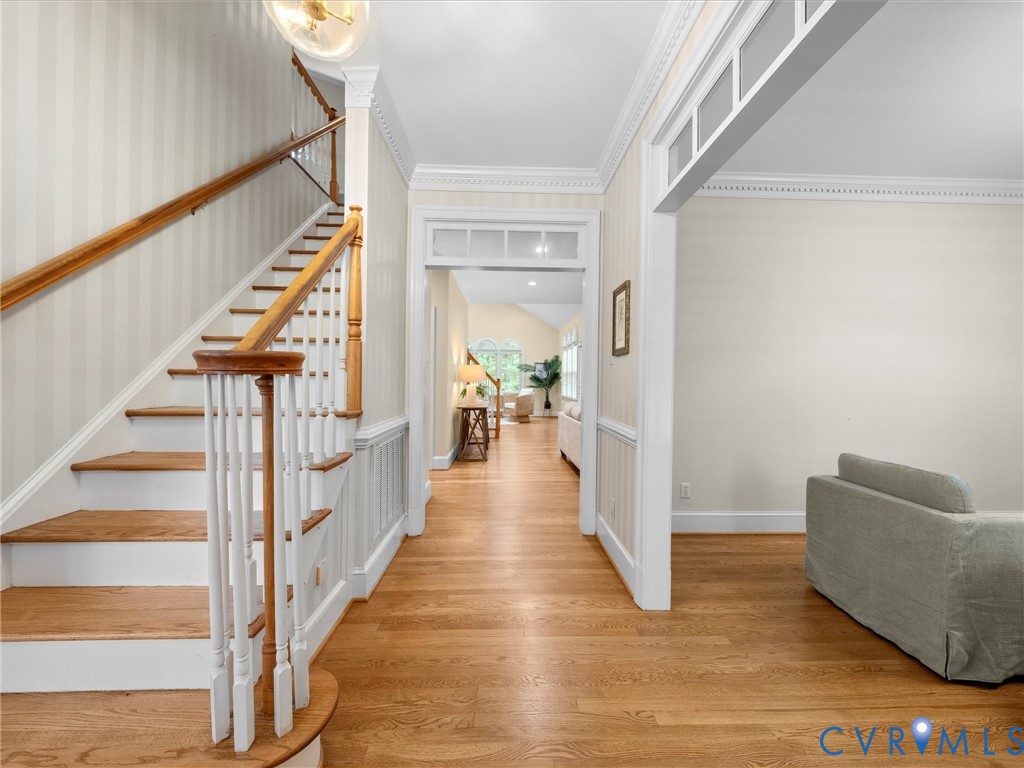 2011 Gamelaw Court Midlothian, VA 23113 - Photo 7 of 77 a view of a hallway with wooden floor and staircase