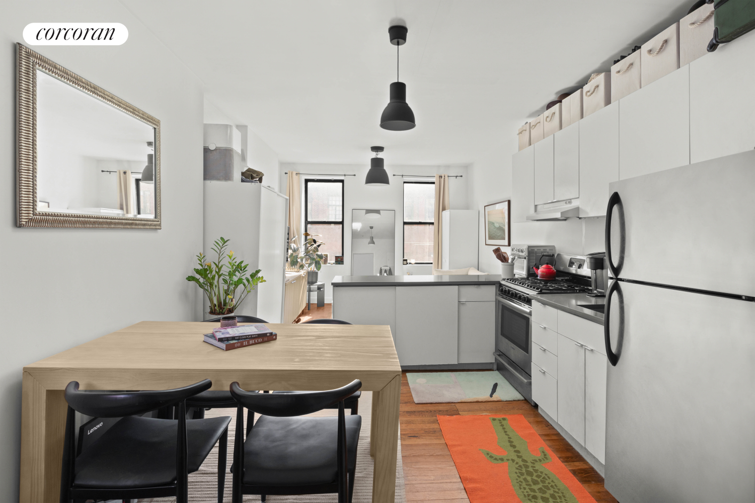 175 Bleecker Street, Unit 18 Manhattan, NY 10012 - Photo 1 of 7 a kitchen with stainless steel appliances granite countertop white cabinets and chairs