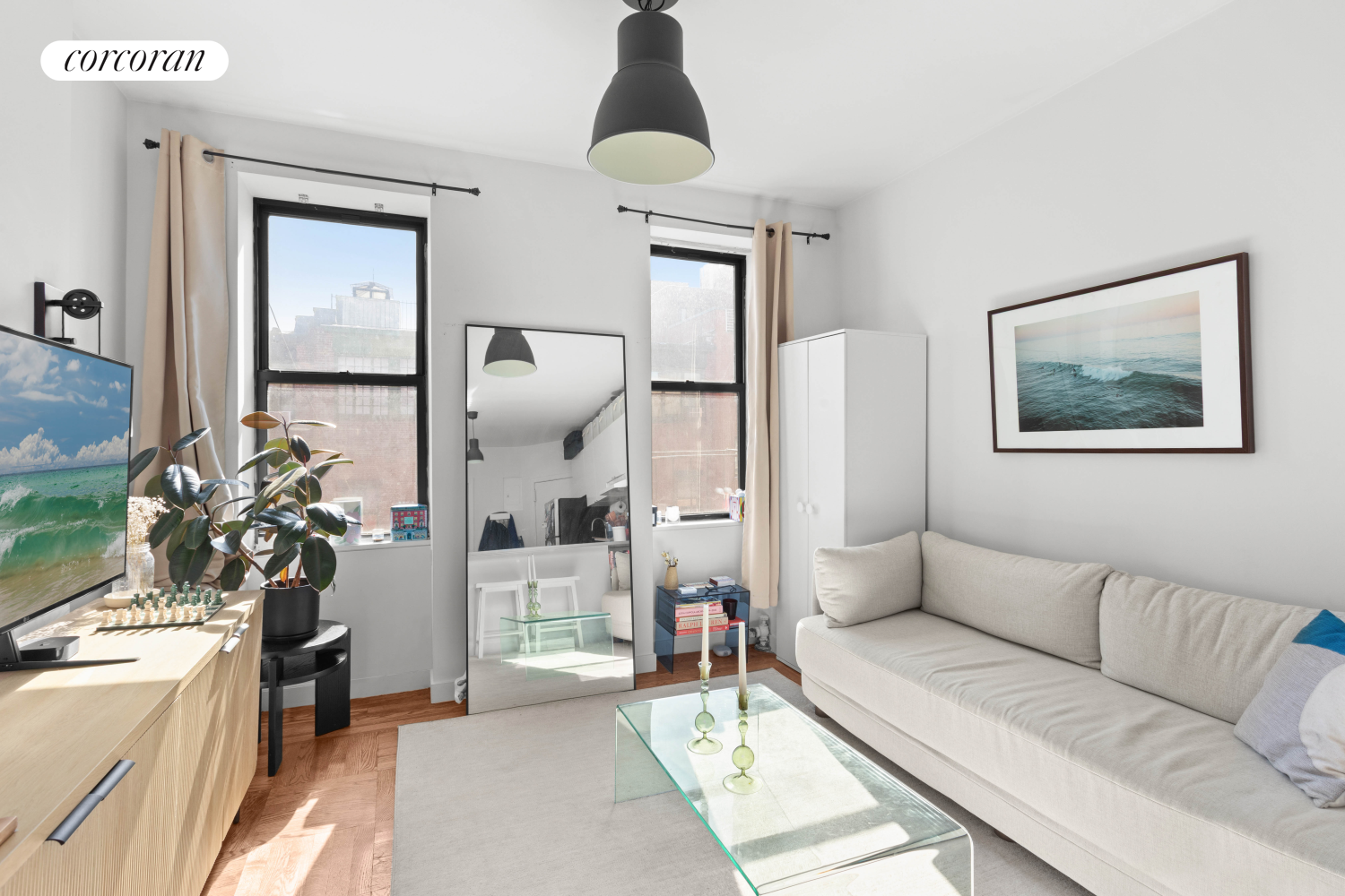 175 Bleecker Street, Unit 18 Manhattan, NY 10012 - Photo 2 of 7 a living room with furniture and a chandelier