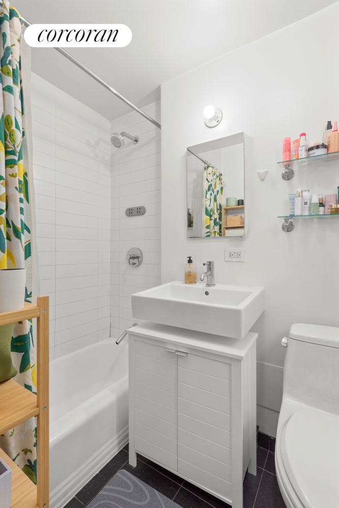 175 Bleecker Street, Unit 18 Manhattan, NY 10012 - Photo 4 of 7 a bathroom with a sink a toilet and a bathtub