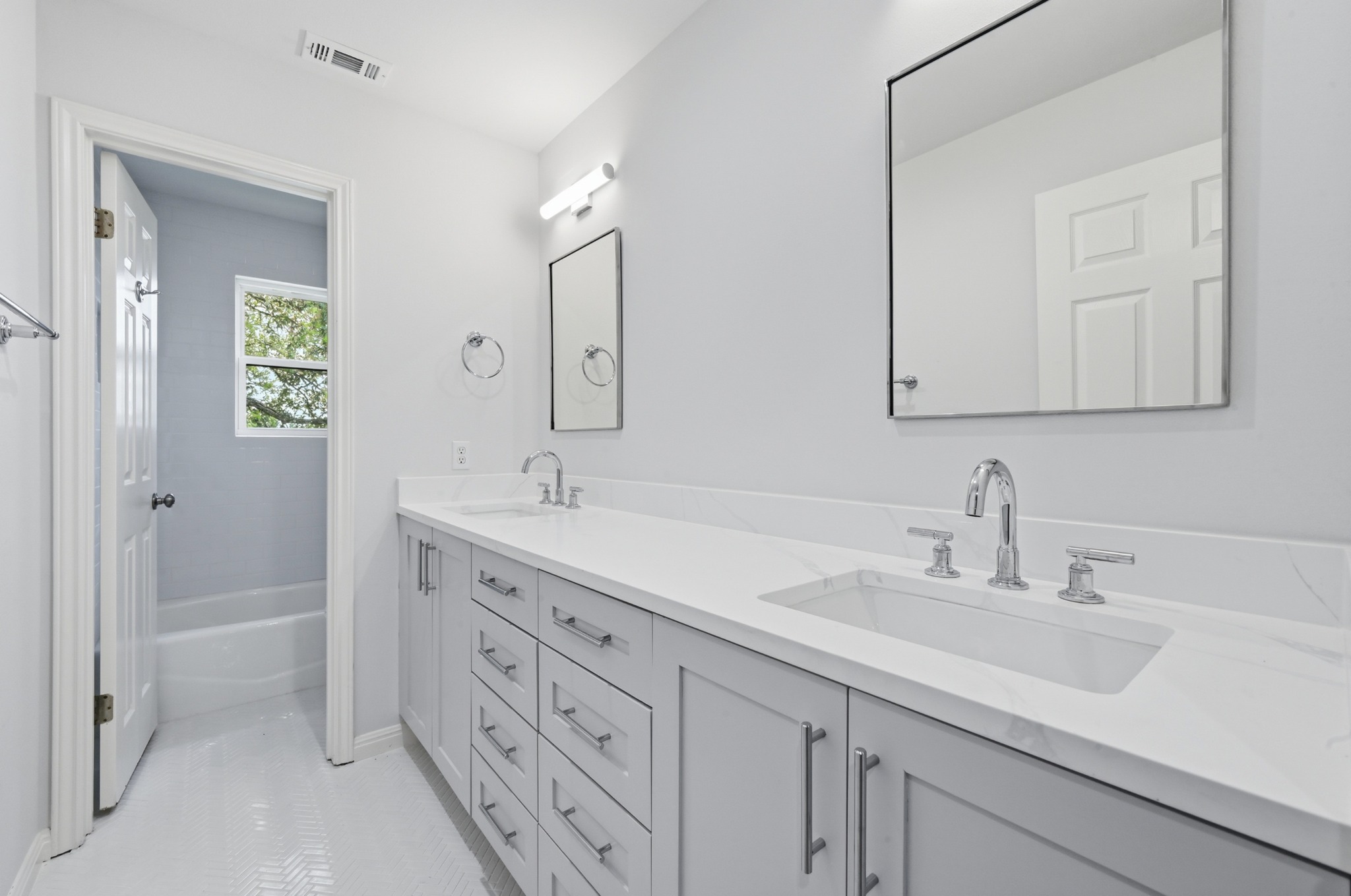 1107 Bowie Road Austin, TX 78733 - Photo 29 of 40 Twin vanities offer ample space in this crisp, modern bathroom.
