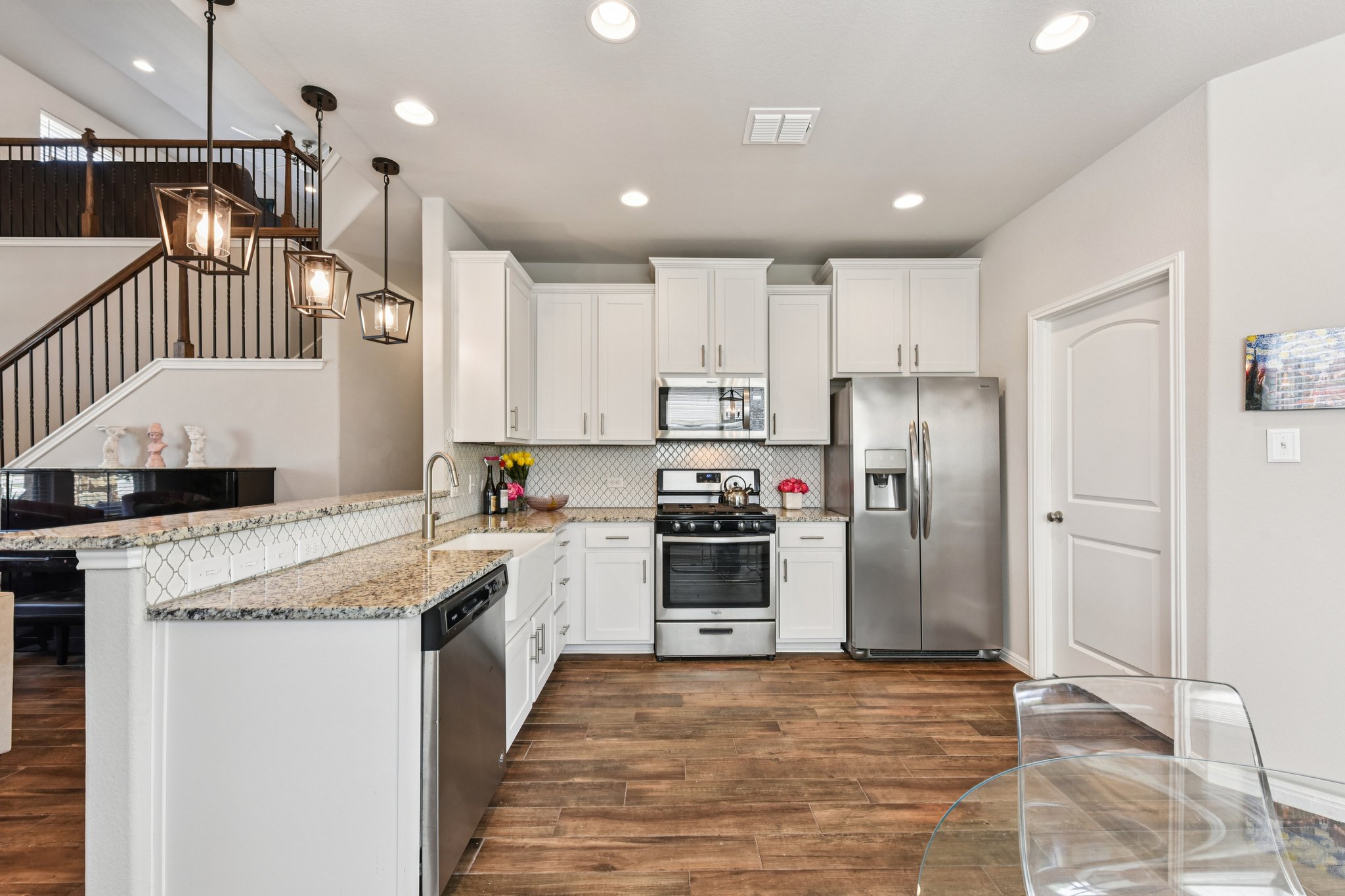 908 Goldilocks Lane Manchaca, TX 78652 - Photo 10 of 34 The kitchen features granite countertops, designer tile backsplash, SS appliances, gas range, farmhouse sink, & beautiful 42” cabinetry.