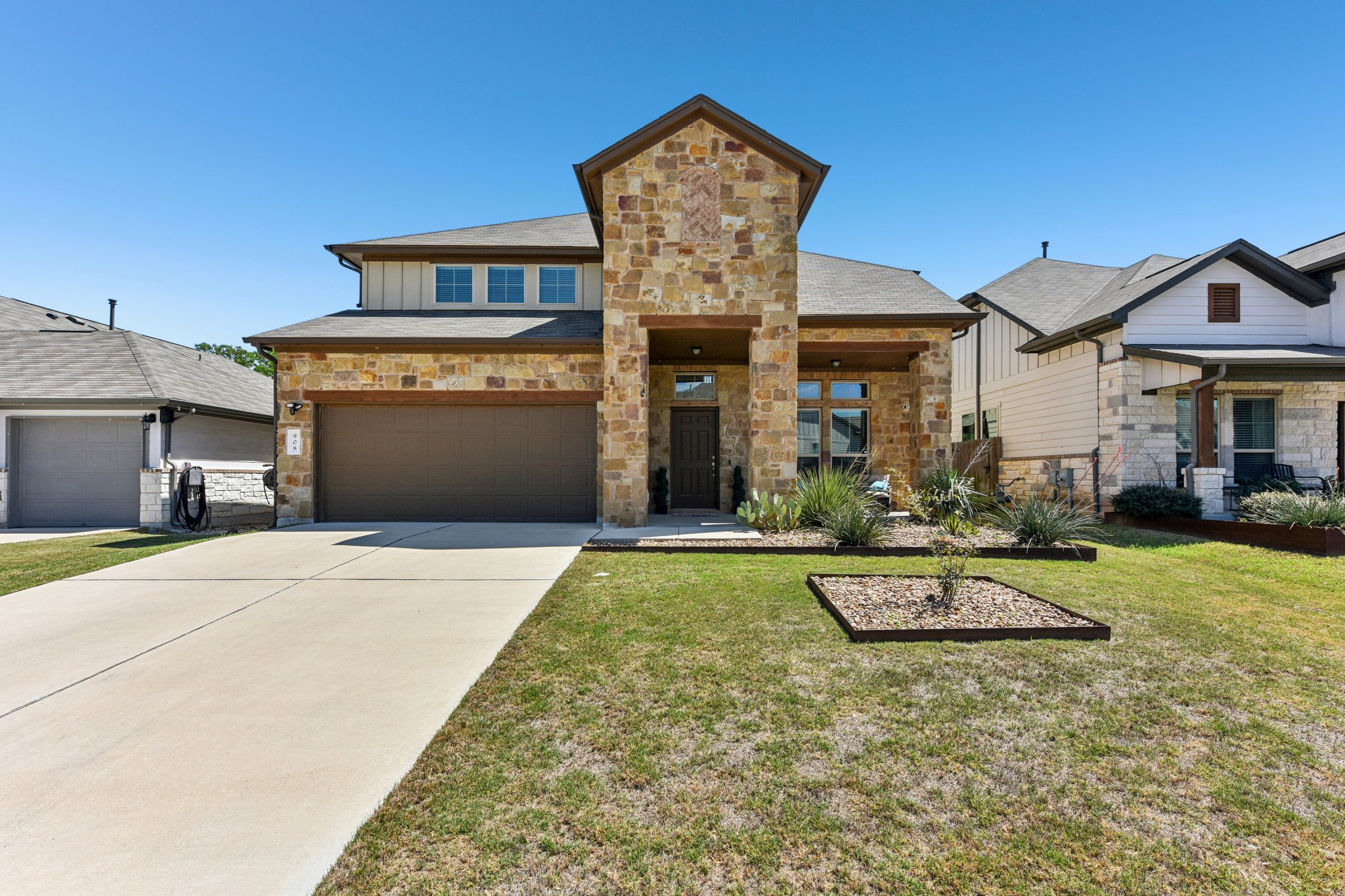 908 Goldilocks Lane Manchaca, TX 78652 - Photo 5 of 34 Excellent curb appeal with stunning stone masonry, professional landscaping.