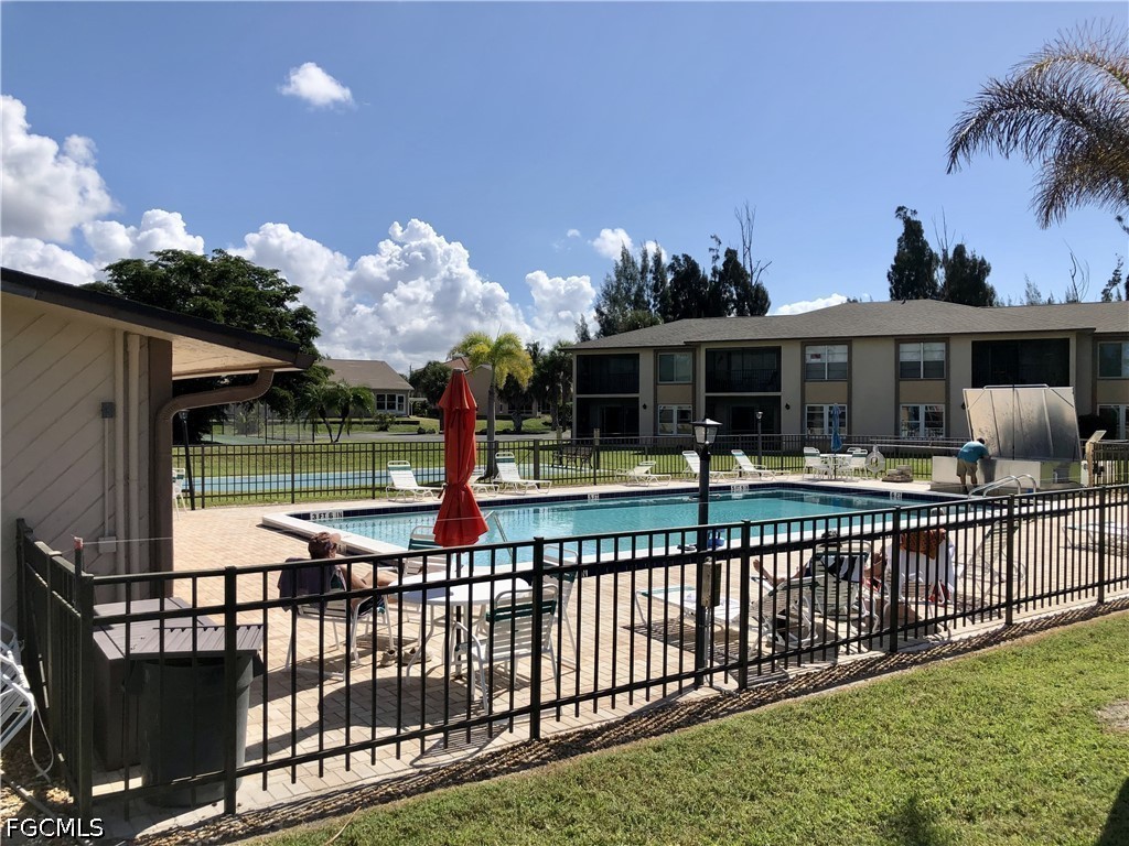 16881 Davis Road, Unit 214 Fort Myers, FL 33908 - Photo 37 of 46 a front view of a house with a garden and swimming pool