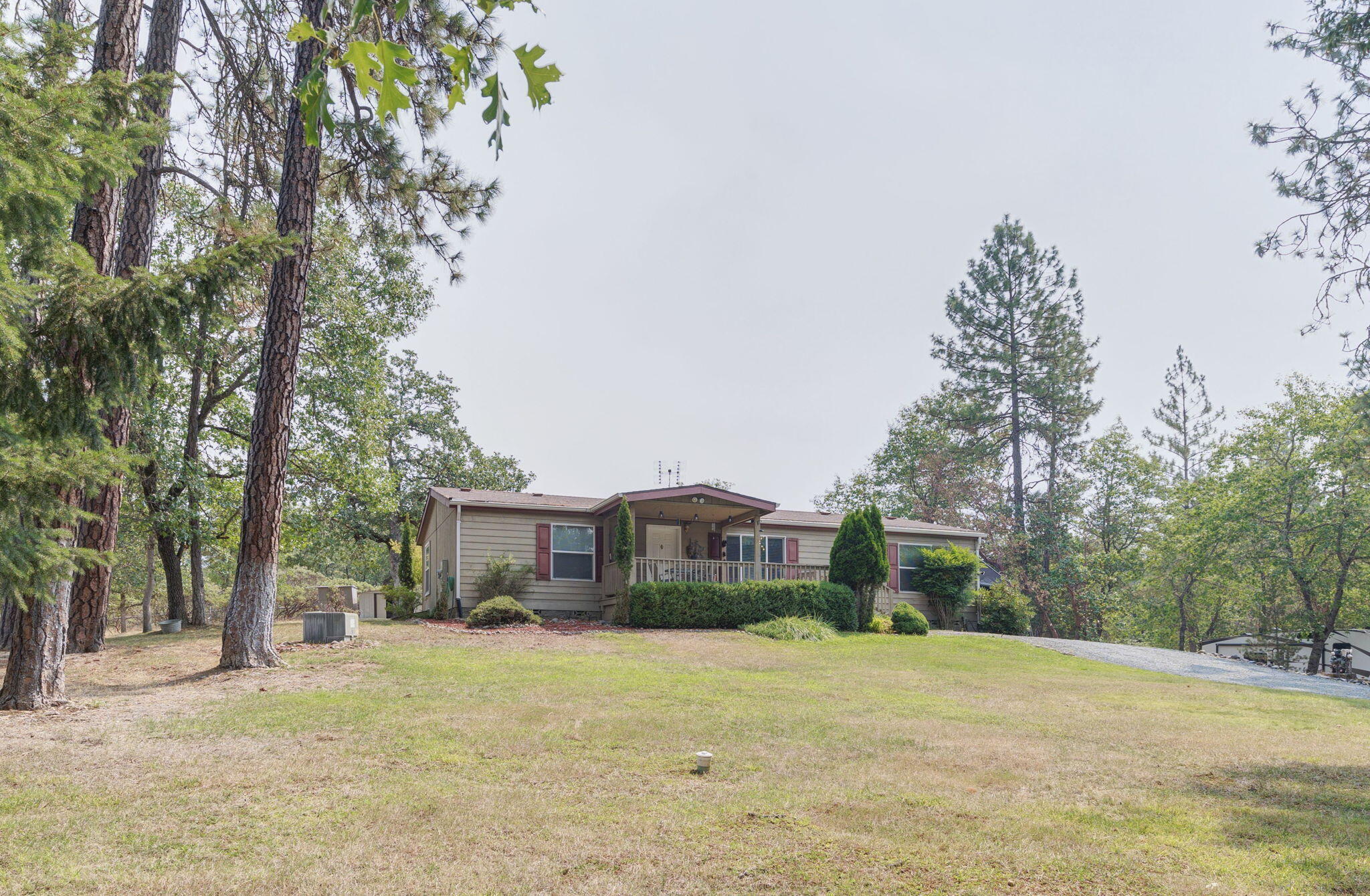 2040 Robertson Bridge Road Grants Pass, OR 97526 - Photo 23 of 39 a front view of a house with a yard and trees