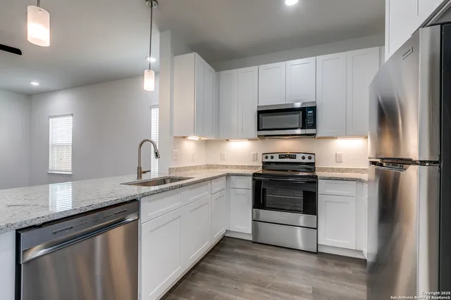 a kitchen with a sink stove and refrigerator