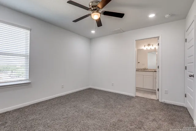 an empty room with closet and windows