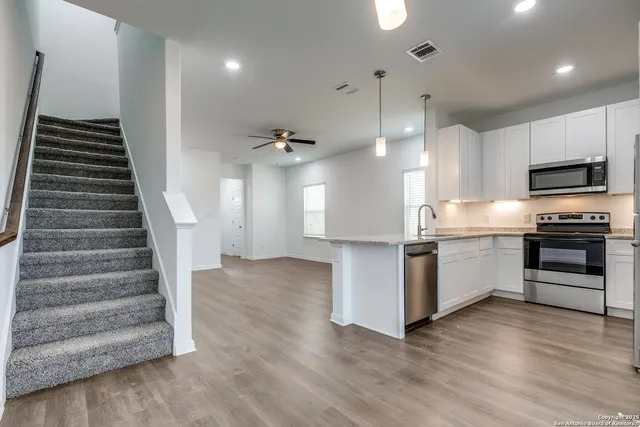 a kitchen with granite countertop a stove and a refrigerator
