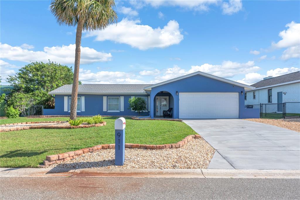911 Silver Palm Way Apollo Beach, FL 33572 - Photo 1 of 35 a front view of a house with a garden and yard