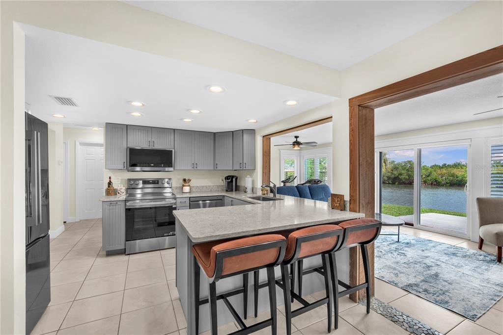 911 Silver Palm Way Apollo Beach, FL 33572 - Photo 16 of 35 a view of kitchen with sink stove and refrigerator