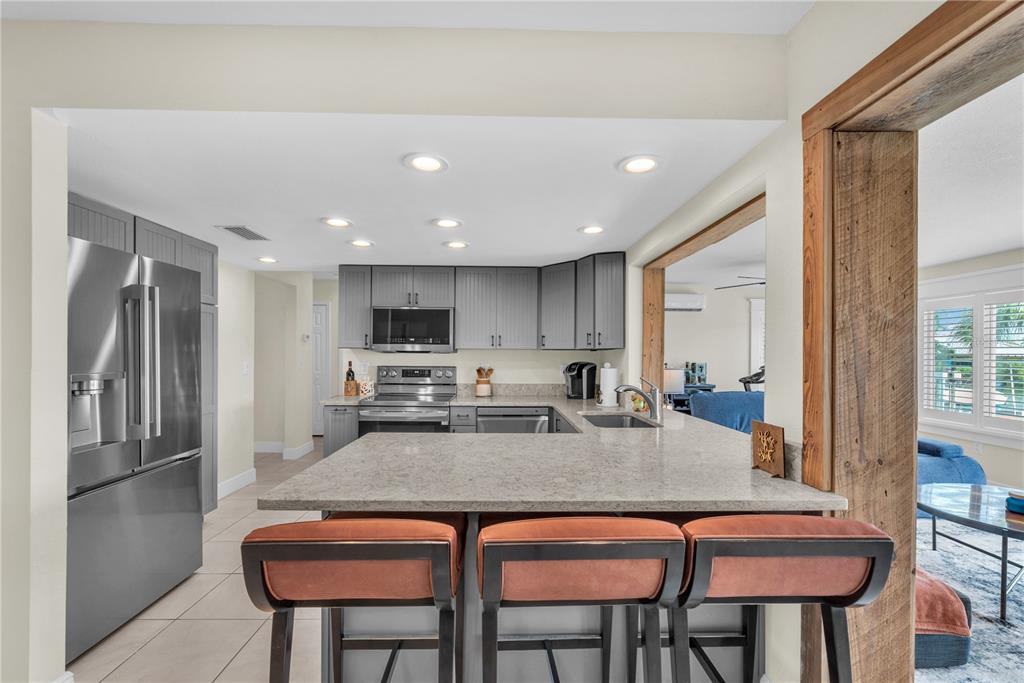 911 Silver Palm Way Apollo Beach, FL 33572 - Photo 17 of 35 a kitchen with a table chairs refrigerator and cabinets