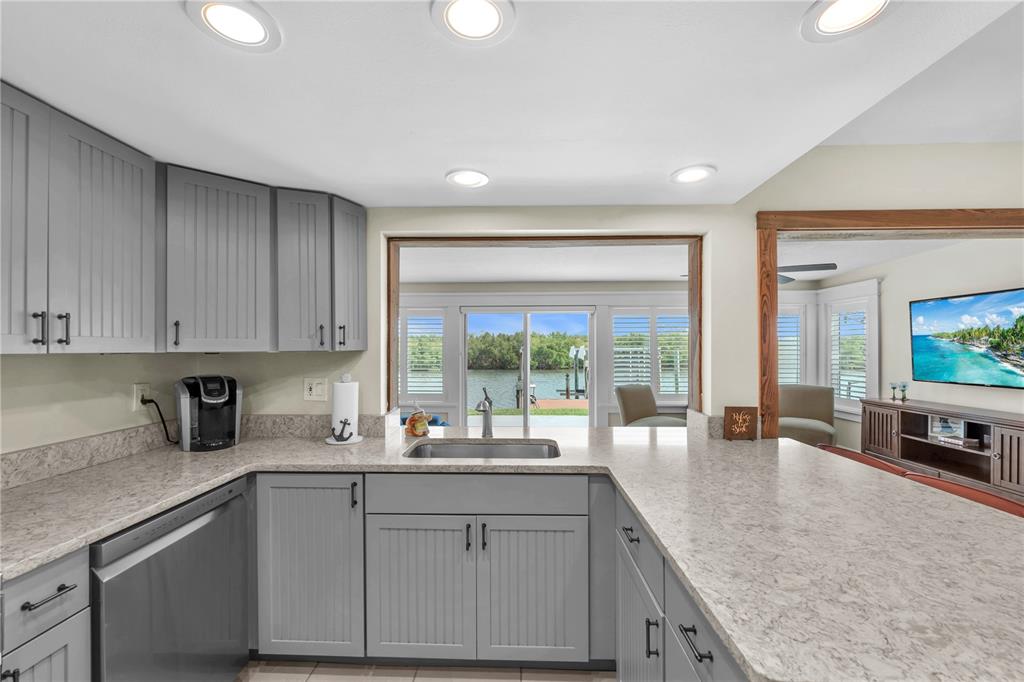 911 Silver Palm Way Apollo Beach, FL 33572 - Photo 21 of 35 a kitchen with sink refrigerator and stove