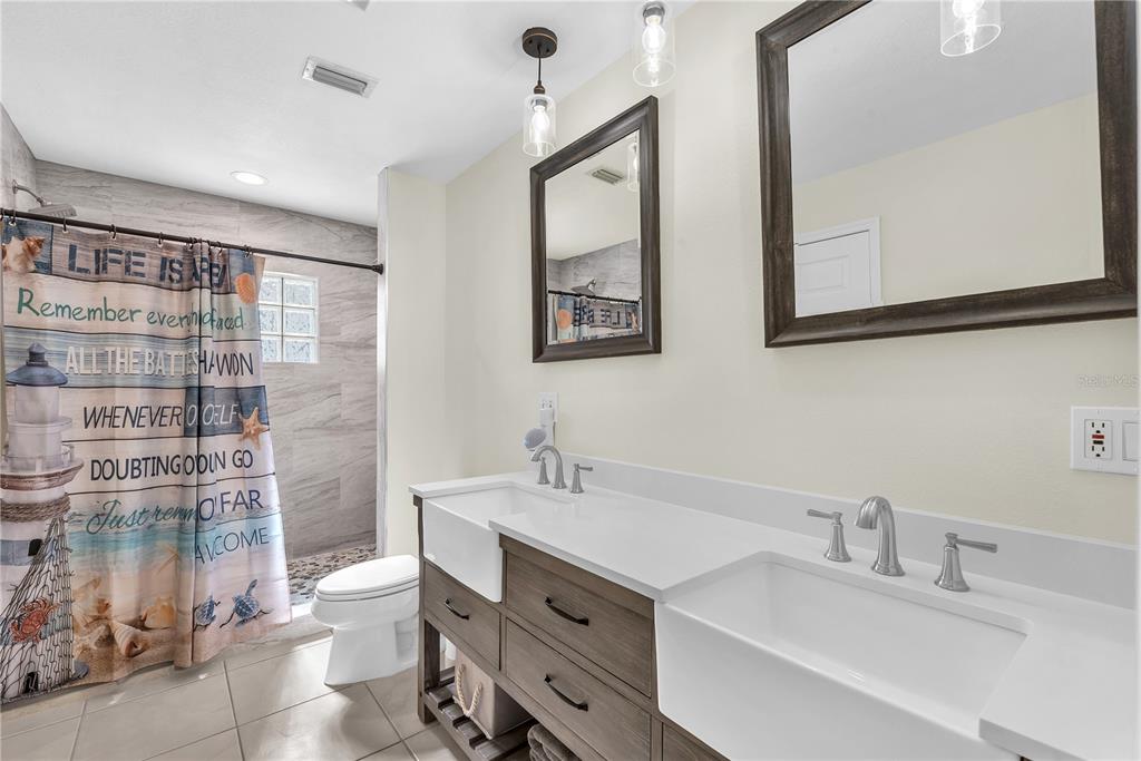 911 Silver Palm Way Apollo Beach, FL 33572 - Photo 27 of 35 a bathroom with a double vanity sink mirror and toilet