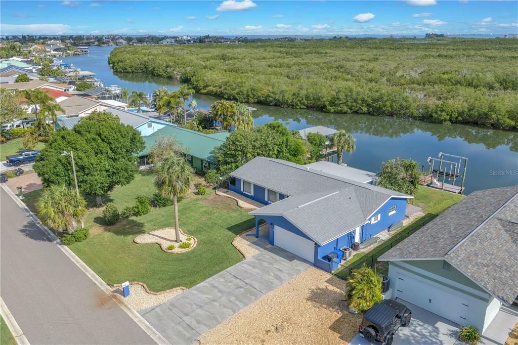 911 Silver Palm Way Apollo Beach, FL 33572 - Photo 33 of 35 an aerial view of a house with a garden and lake view