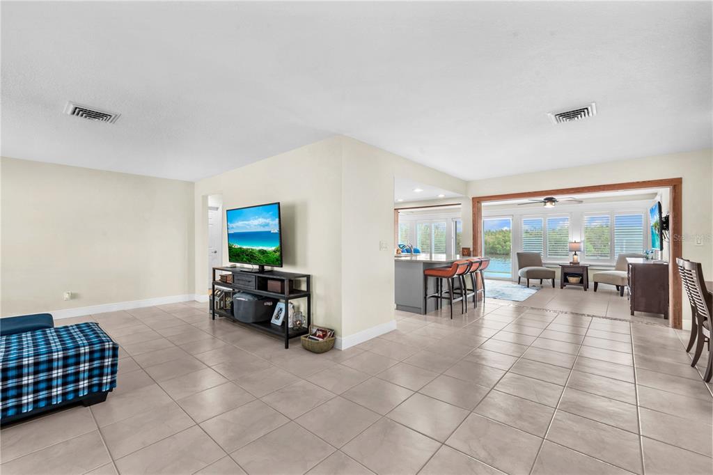 911 Silver Palm Way Apollo Beach, FL 33572 - Photo 9 of 35 a living room with furniture and a dining table with wooden floor