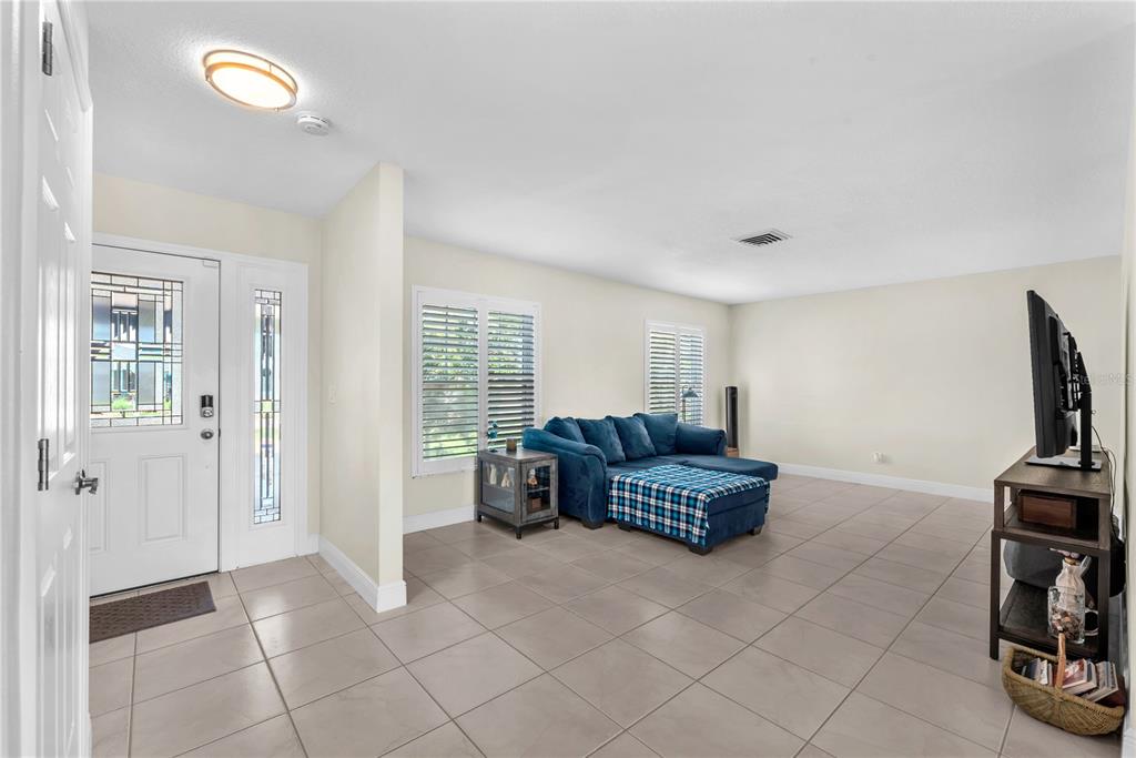 911 Silver Palm Way Apollo Beach, FL 33572 - Photo 10 of 35 a living room with furniture and a flat screen tv