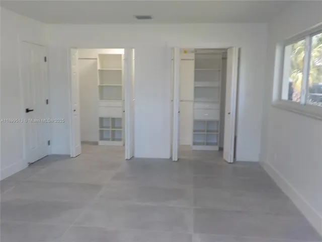 a bathroom with a granite countertop sink double and mirror