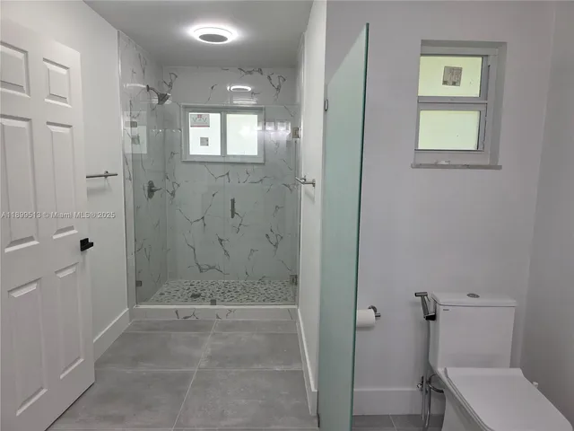 a bathroom with a toilet and a tub