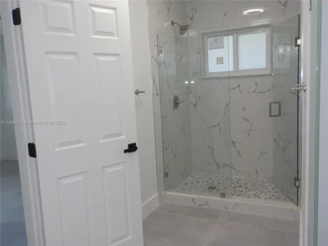a kitchen with stainless steel appliances granite countertop a sink and a refrigerator
