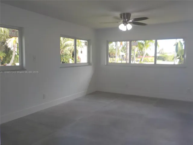 a kitchen with granite countertop a refrigerator and a sink