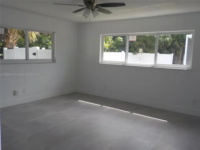 a kitchen with stainless steel appliances kitchen island granite countertop a sink and a refrigerator