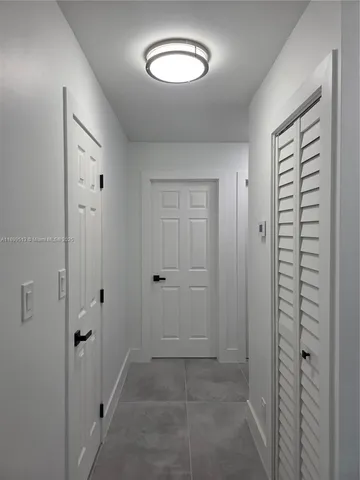 a view of kitchen with refrigerator and window