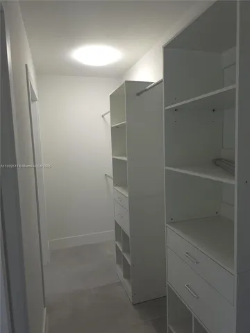 a view of a room with shelves on the wall