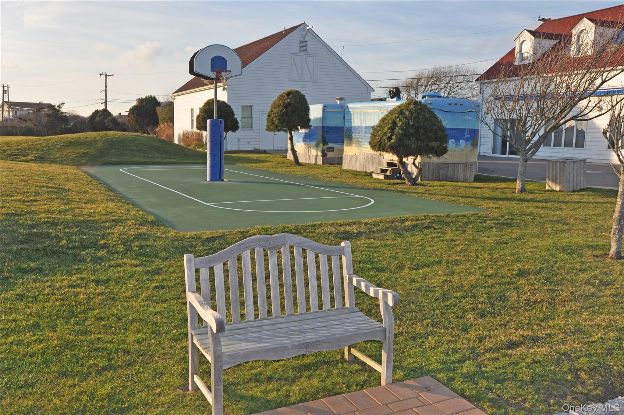 100 Deforest Road, Unit 25 Montauk, NY 11954 - Photo 18 of 21 View of basketball court featuring a lawn and community basketball court