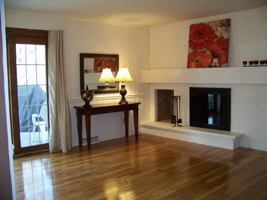 3518 North View Road Rockford, IL 61114 - Photo 5 of 10 a view of a livingroom with wooden floor and a fireplace