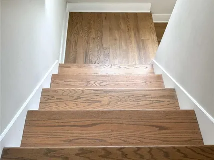 a view of a hallway with closet and bathroom