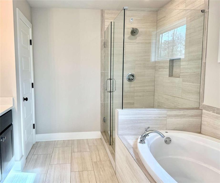 2362 Browns Mill Road Southeast Atlanta, GA 30315 - Photo 25 of 41 a bathroom with a tub and shower