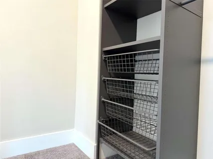 an empty room with windows and closet