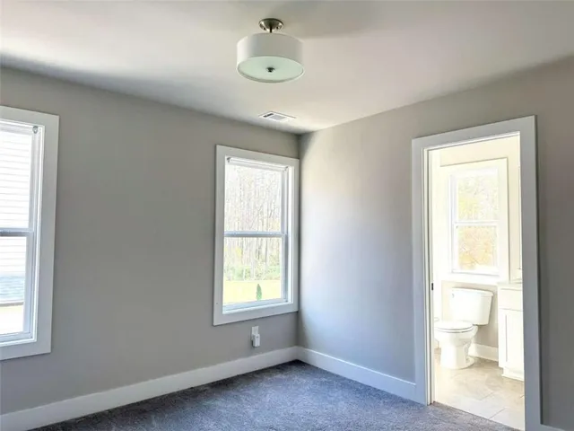 an empty room with windows and closet